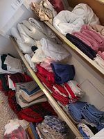 Shelf with stacked linens in multiple colours and types