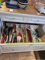 Open drawer showing majority of utensils organised by divider