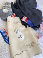 Group view of all scarves and slippers on bed