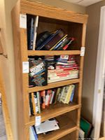 Full view of oak bookcase filled with books