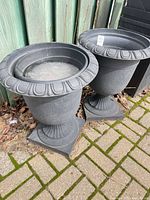 Both gray resin urn planters side by side showing general appearance