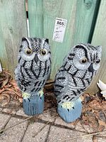 Front view of both resin owl ornaments on blue bases