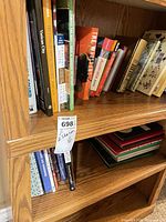 Shelf view showing multiple paperback books including travel and self-help titles