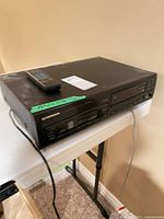 Full view of CD changer with remote on top