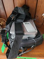 Player, power adapter and carrying bag stacked together