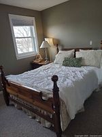 Full view of assembled queen bed showing headboard, footboard, mattress, and box spring