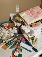 Overall lot with quilted fabric, unfinished quilt top, hoops, trim and packaged notions