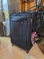 Front angled view showing overall suitcase, front pocket, wheels