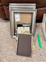 Stack of silver frames and accessories