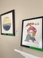 Both framed prints on wall, size labels visible