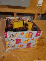 Decorative box containing assorted shoe care items