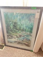 Full view of framed landscape artwork against wall