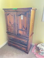 Front view of pine armoire showing double doors and two drawers