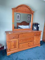 Front view of solid pine dresser with attached mirror and all drawers/doors visible