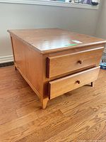 Three-quarter view showing drawers and side panel