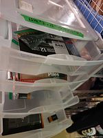 Storage tower drawers labelled with dimensions and containing battery packs