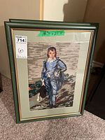 Front view of framed needlepoint portrait (boy) showing image, mat, frame and glass