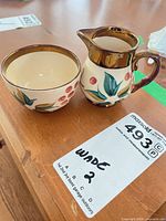 Creamer and sugar bowl side view showing pattern and rim