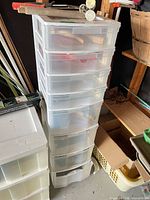 Full view of plastic 7-drawer organizer with contents and garden tools on top