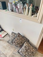 Lot overview showing figurine, stained glass ornament on ledge and pillow on floor