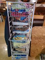 full view of white wire storage tower filled with towels