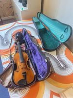 Violin in both cases, cases open showing interiors