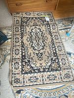 Full view of rectangular beige patterned rug on floor