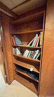 Front view of built-in bookcase with books on shelves