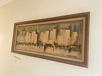Full view of framed abstract cityscape print on wall