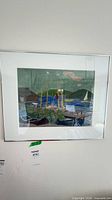Front view of framed harbor watercolor under glass