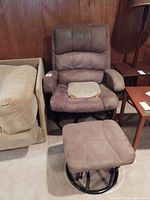 Front view of chair and ottoman showing upholstery and base