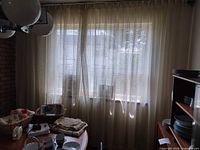 Curtain panels hung across window showing color, weave and length