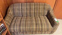 Front view of plaid tweed loveseat