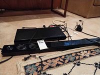 Philips DVD player, LG sound bar, cables on floor