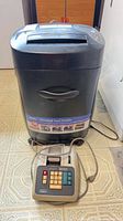 Royal 16CDX crosscut paper shredder with vintage printing calculator in front