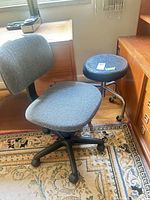 Chair and stool together showing overall style, upholstery, bases