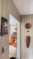 Copper plaque, wooden plate, wood mask on wall
