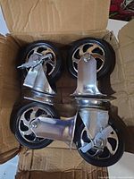 box containing four swivel caster wheels