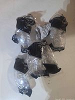 Six of the seven sealed safety glasses in plastic