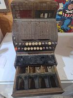 Full view of antique wooden cash register showing keys and indicator windows
