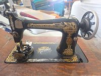 Left side view of Singer sewing machine showing decals and wheel