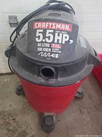 Exterior of Craftsman 5.5 HP 60 L shop vac on caster base