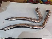 Full view of both chrome exhaust pipes on table