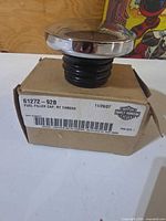 Cap on box showing label with part number and branding