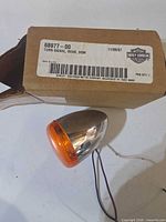 Turn signal and original box showing part number label