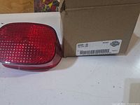 Tail light lens beside original Harley-Davidson box