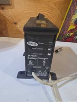 Front view showing Invacare branding, LED indicators, specifications