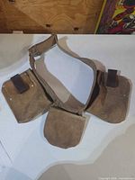 Full view of three-pouch suede leather tool belt laid flat