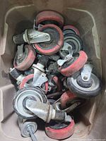Bin filled with numerous red-tread swivel casters
