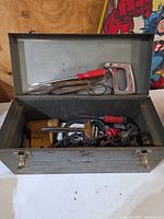 Open metal toolbox with contents visible